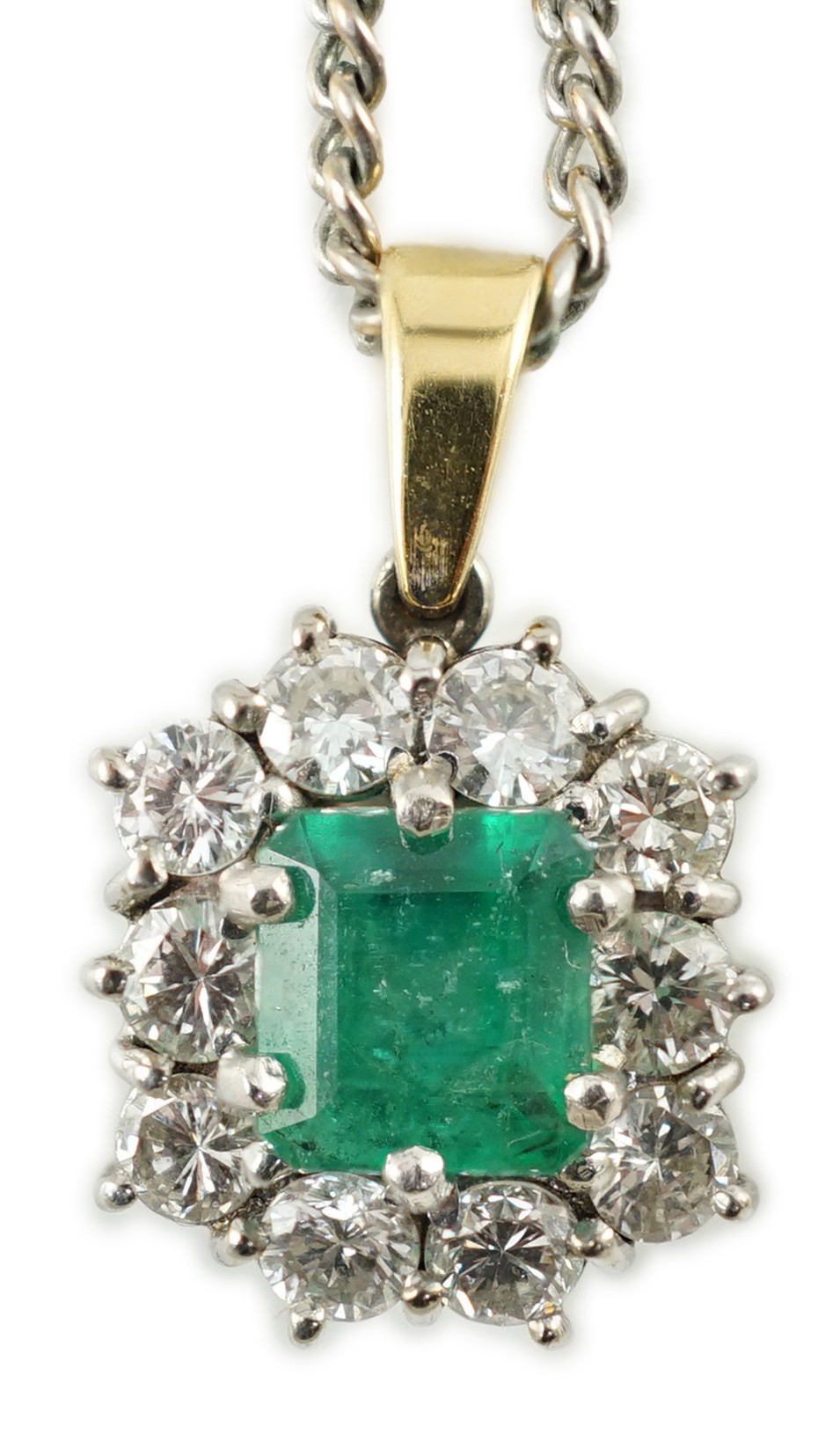 An 18ct white and yellow gold, emerald and diamond set shaped rectangular cluster pendant, on a 9ct white gold chain